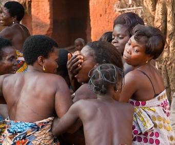 IMG-4138 Dancers at Voodoo Ceremony, Togo. The women dance until entering a trance, their eyes are closed by other women who carry them to a hut.